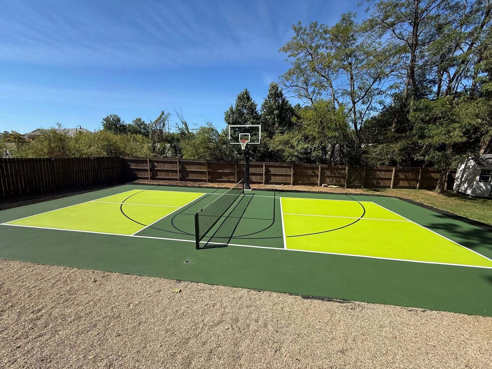 Backyard basketball court with green acrylic surface
